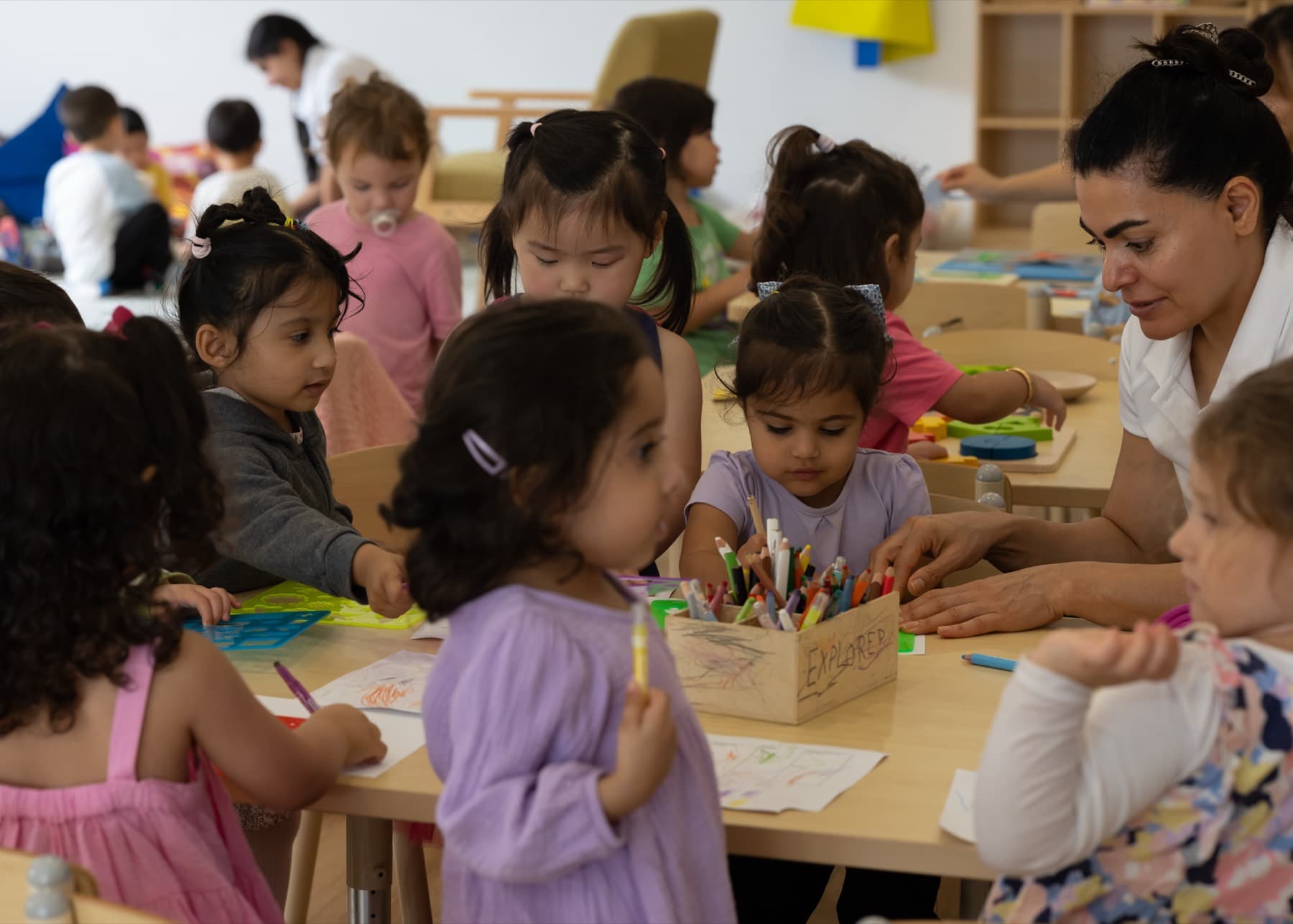 Children drawing and painting together at a table