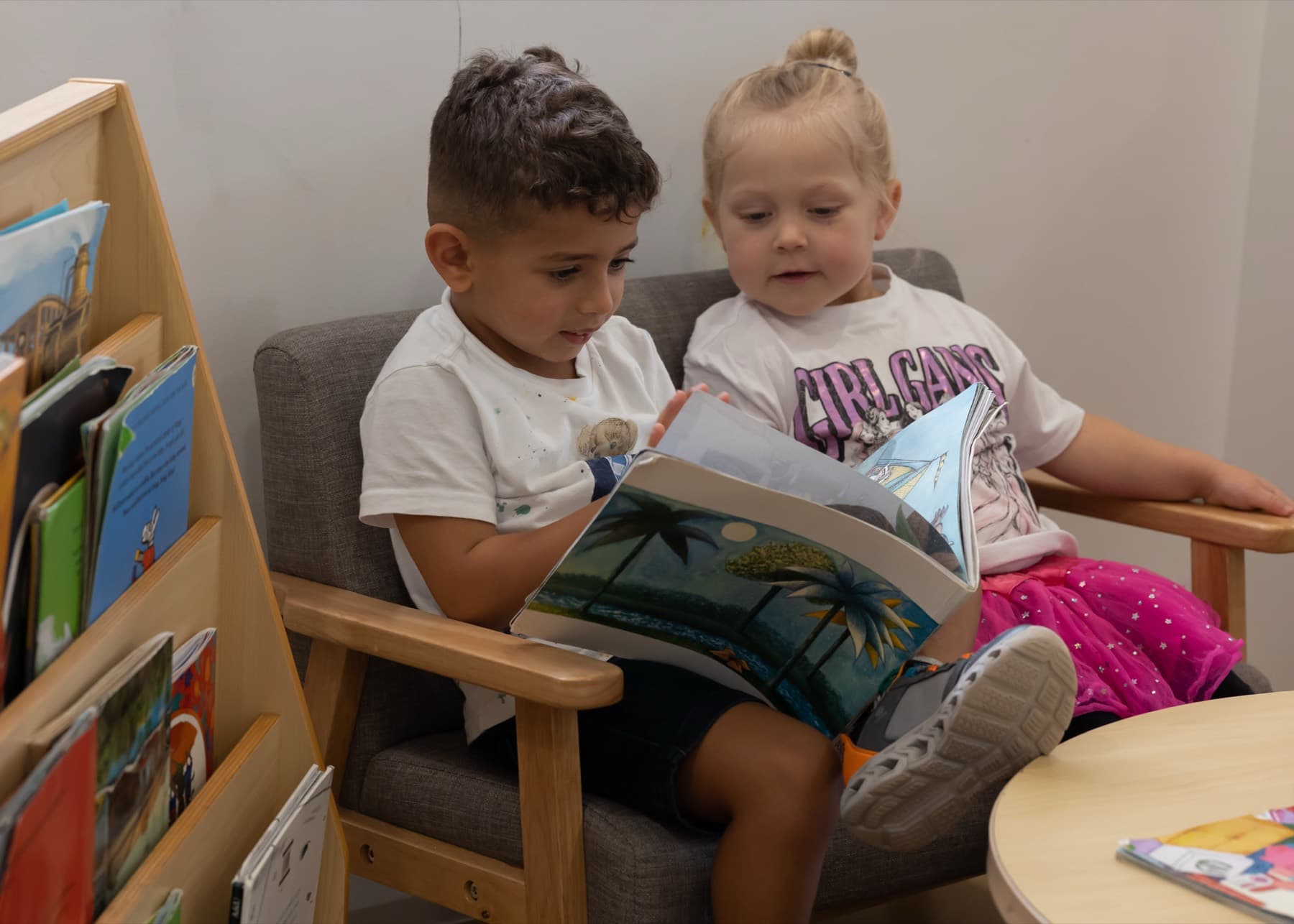 Two children reading a book together
