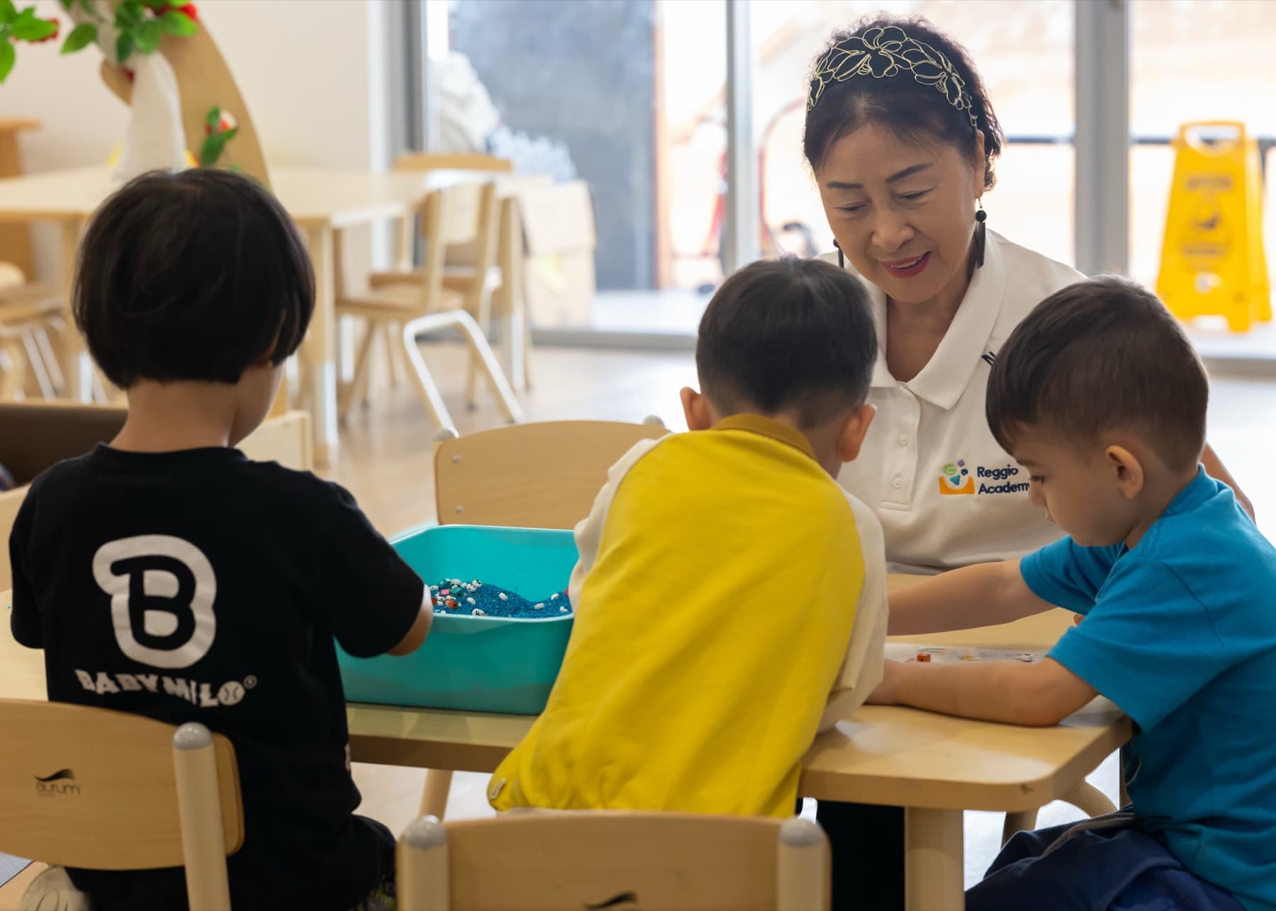 An educator working with a small group at a table