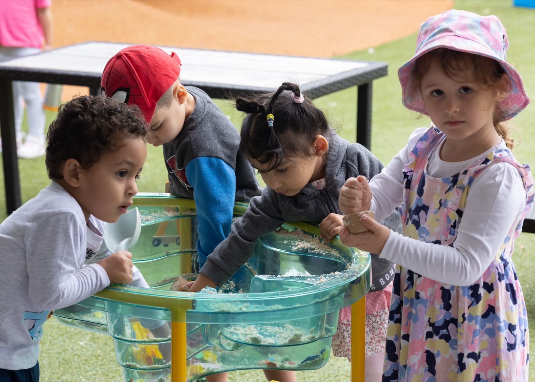 Children playing together at a water table